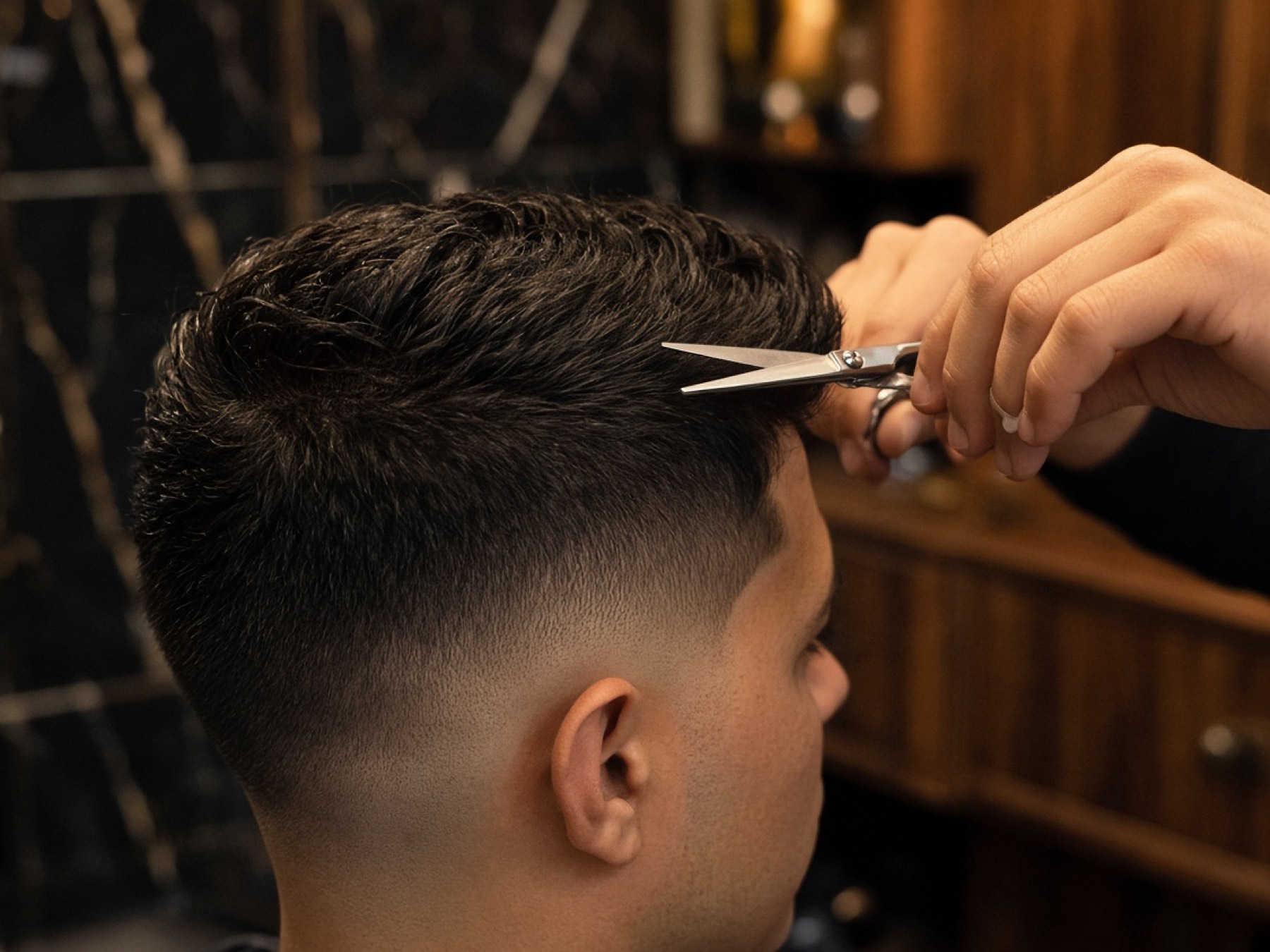Scissors working through a precision men's haircut